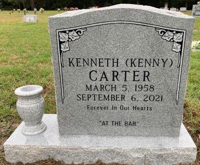gray granite upright headstone with ivy border and flower pot
